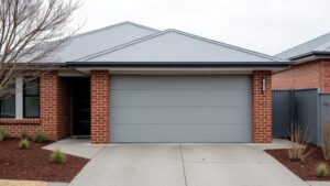 Garage Doors Compared for Melbourne Homes: Sectional, Roller and Tilt Closed light grey double sectional garage door on a brick and render Melbourne home with a plain concrete driveway