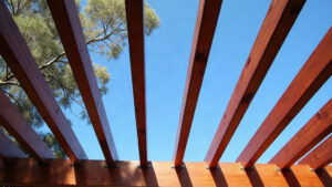 How Much Does a Pergola Cost in Melbourne? Key Price Drivers Timber pergola rafters and bearer seen from below against a blue Australian sky